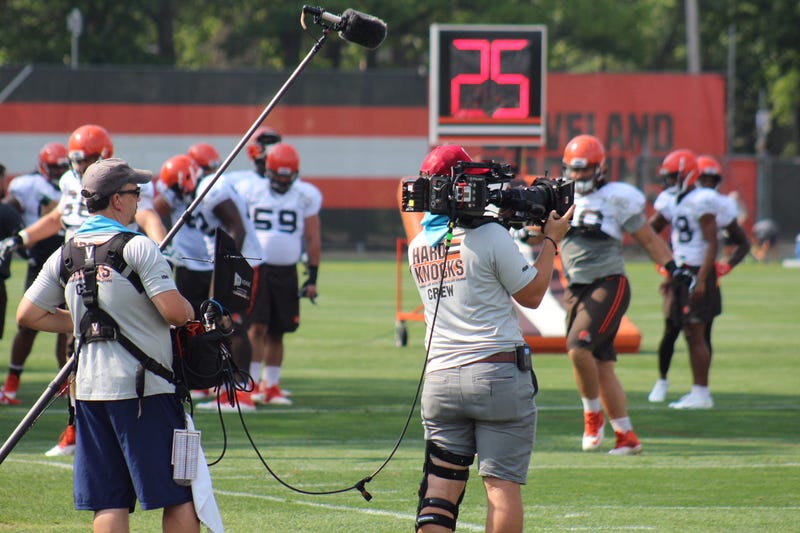 An NFL Films crew films for HBO's Hard Knocks during practice