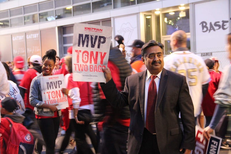 A fan holds a "Finish The Fight" card outside Nationals Park before Game 4 of the World Series.