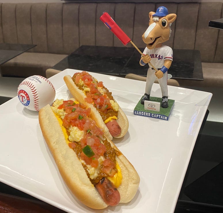 Rangers' foot-long hot dog topped with chili, nacho cheese and creamy jalapeño grits