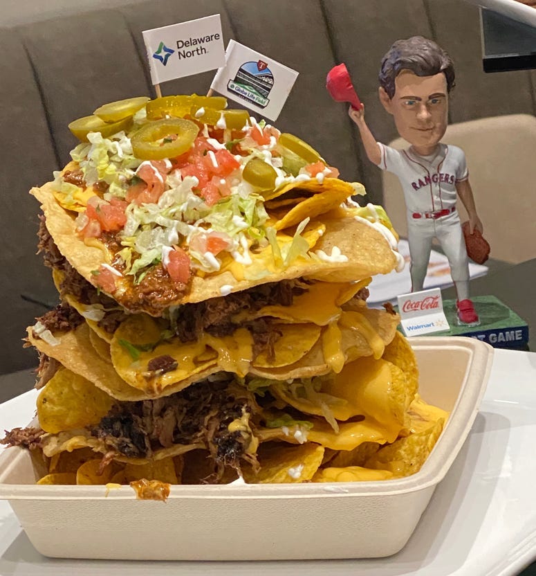 Layered nachos using fried tortillas as chips, measuring six inches high
