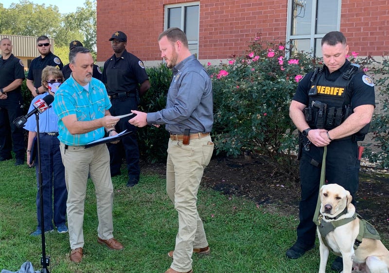 Stephen Combs of Anderson Area Crimestoppers presents Anderson County Sheriff Chad McBride with $2,500 donation in honor of fallen K9 officer Roscoe.