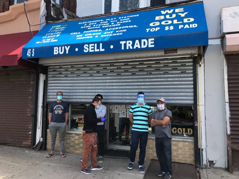 Men standing in front of MN Wireless on 52nd Street