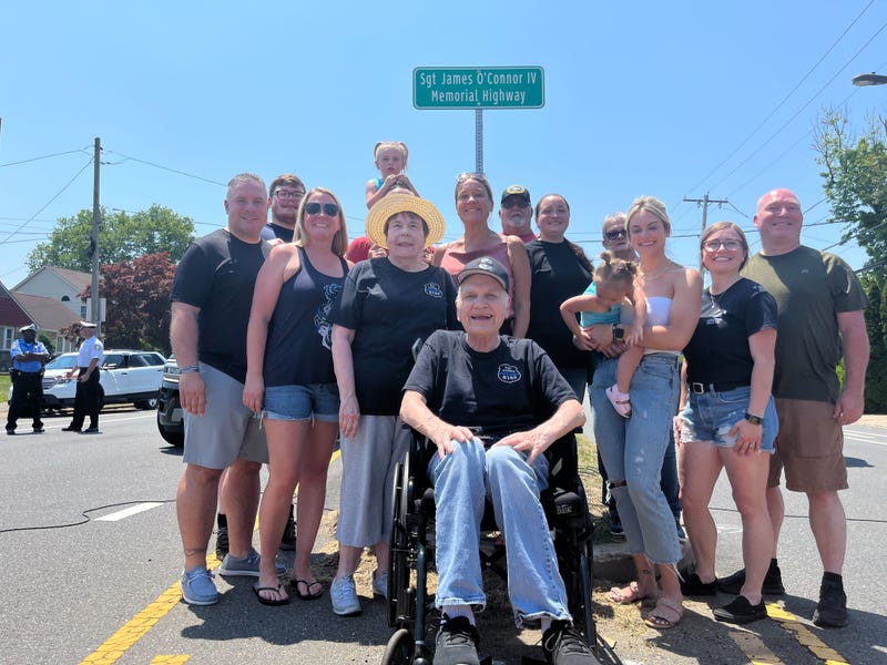 Sgt. James O’Connor IV's family members pose in front of a stretch of Knights Road in Northeast Philadelphia that was renamed after him.