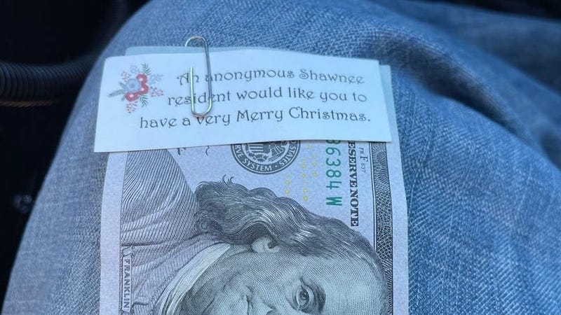A note attached to a $100 bill handed out by Secret Santa.