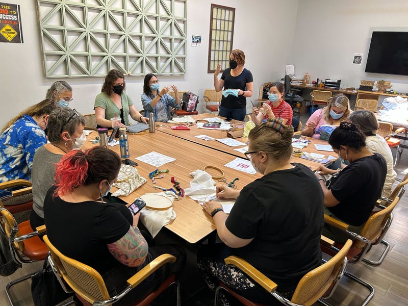 A so-called "Craftivism," workshop takes place at the WasteShed, led by Shannon Downey.