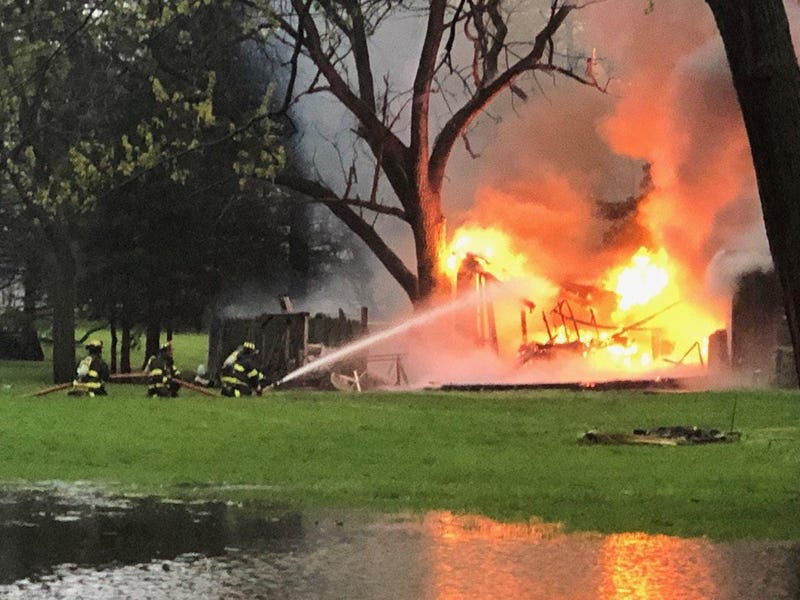 An off-duty Lisle-Woodridge firefighter rescued three people Wednesday from a burning home in west suburban Lisle. 
