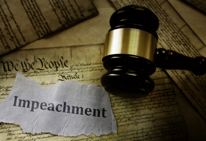 Impeachment message on pages of the US Constitution with legal gavel