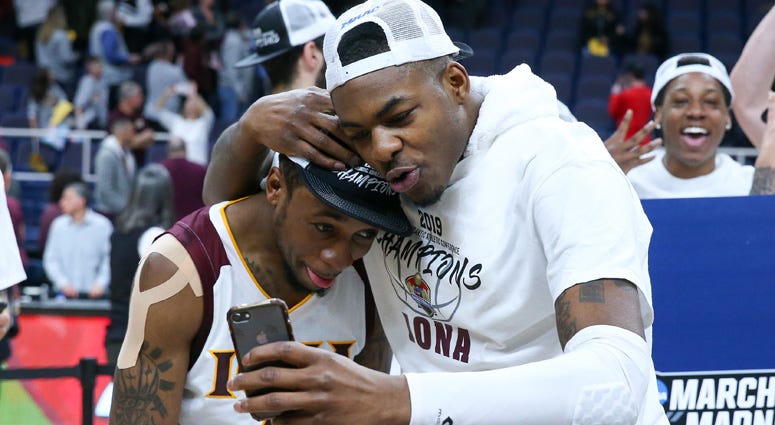 Iona Gaels guard Rickey McGill (left) and forward Tajuan Agee (right) celebrate following the MAAC Conference Tournament Championship game against the Monmouth Hawks at the Times Union Center in Albany on March 11, 2019.