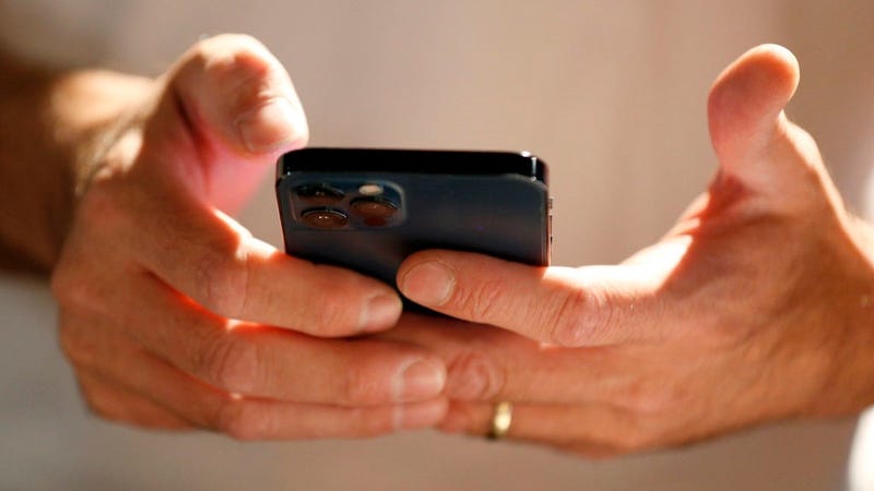 A person scans and downloads an app to start the process of converting their physical driver license to an official digital version to be stored on a mobile phone at a Harmons Grocery store on August 4, 2021 in Salt Lake City, Utah.
