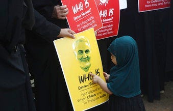 An Indian Shiite Muslim girl points at a portrait of Iranian Gen. Qassem Soleimani who was killed in a U.S. attack, during a protest against the U.S. in Mumbai, India, Thursday, Jan. 9, 2020. (AP Photo/Rafiq Maqbool)