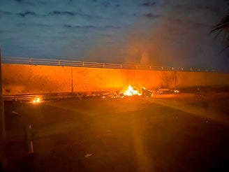 This photo released by the Iraqi Prime Minister Press Office shows a burning vehicle at the Baghdad International Airport following an airstrike, in Baghdad, Iraq, early Friday, Jan. 3, 2020. (Iraqi Prime Minister Press Office via AP)