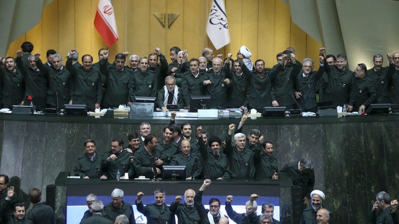 Wearing the uniform of the Iranian Revolutionary Guard, lawmakers chant slogans during an open session of parliament in Tehran, Iran, Tuesday, April 9, 2019.