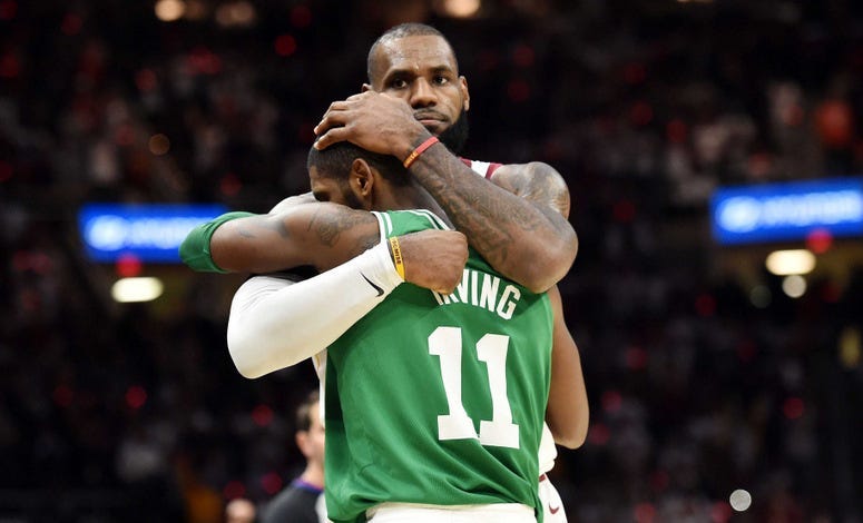 Kyrie Irving hugs LeBron James.