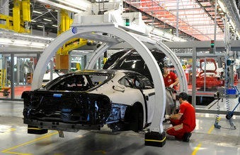 FILE - In this Wednesday, May 8, 2013 file photo, a technician works at the Ferrari department factory in Maranello, Italy. (AP Photo/Marco Vasini, File)