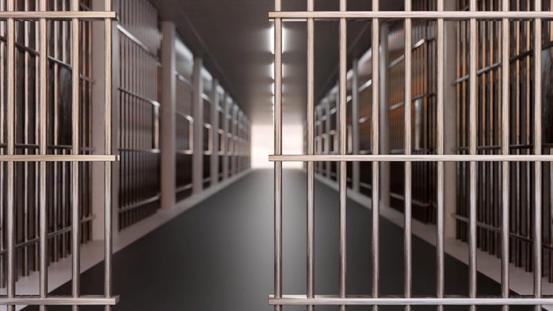 jail cell and open metal bars door, empty dark facility hall interior