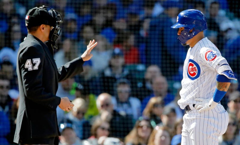 Cubs shortstop Javier Baez (9) talks with home plate umpire Gabe Morales after being called out on strikes.