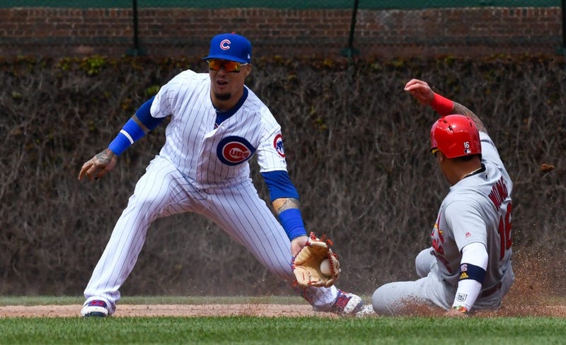 Cardinals second baseman Kolten Wong (16) is forced out at second base by Cubs shortstop Javier Baez (9).