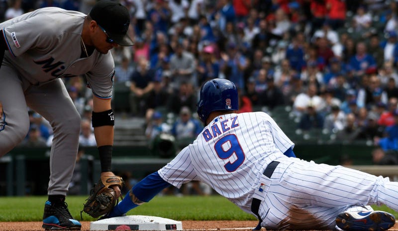 Cubs shortstop Javier Baez slides safely into third base.
