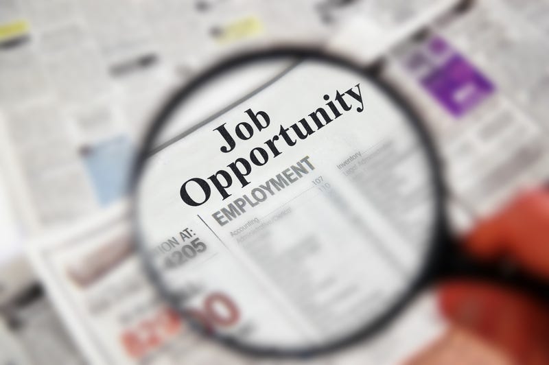 job search in newspaper using magnifying glass