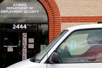 A man looks at the closed sign in front of Illinois Department of Employment Security in Chicago, Wednesday, April 15, 2020. (AP Photo/Nam Y. Huh)