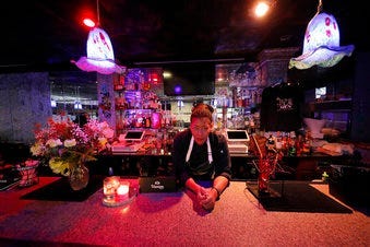 In this Tuesday, March 24, 2020, photo, Keisha Henry poses for a portrait inside her lounge and catering business in New Orleans. (AP Photo/Gerald Herbert)