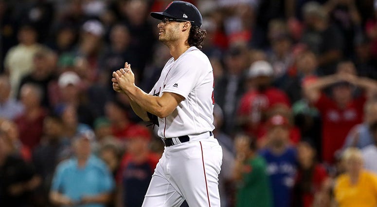 Boston Red Sox relief pitcher Joe Kelly (56) reacts after hitting Toronto Blue Jays centerfielder Kevin Pillar (11) with a pitch that brought in the tying run during the eighth inning at Fenway Park.