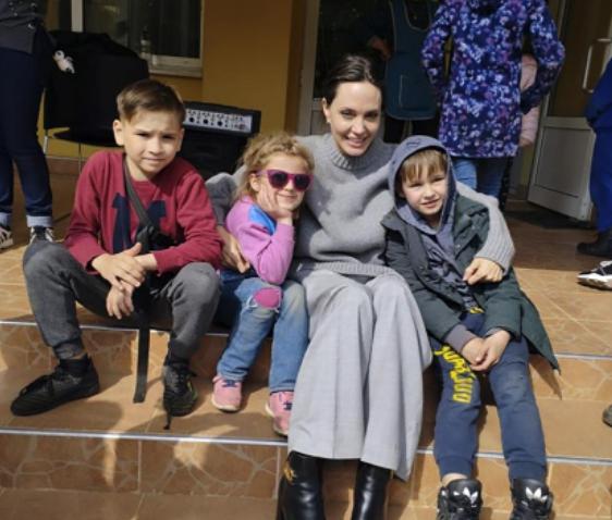 In this image provided by the Lviv city hall Angelina Jolie, Hollywood movie star and UNHCR goodwill ambassador, poses for photo with kids in Lviv, Ukraine, Saturday, Apr. 30, 2022. Ms Jolie was in Ukraine to meet the children affected by the war and visited hospitals and NGOs helping the injured and displaced.