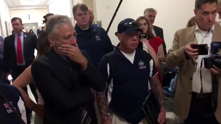 Jon Stewart Receives FDNY Legend's Coat In Emotional Moment Before Blasting Lawmakers At 9/11 Hearing