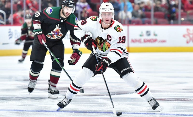 Blackhawks center Jonathan Toews (19) carries the puck as Coyotes center Brad Richardson (15) defends.