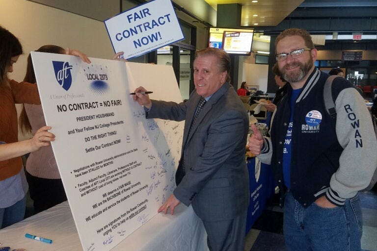 AFT local 2373 President Dr. Joseph Basso and Vice President Gerald Hough sign a petition board at Rowan University.