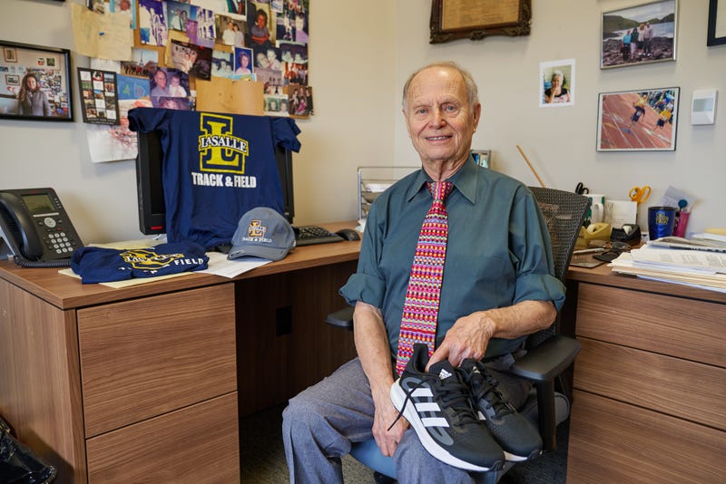 Dr. Joshua Buch holding running sneakers in his office