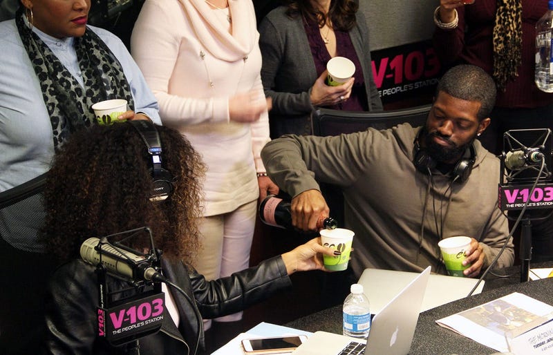 JR of The Morning Culture pouring Moet Champagne for co-host Jade Novah