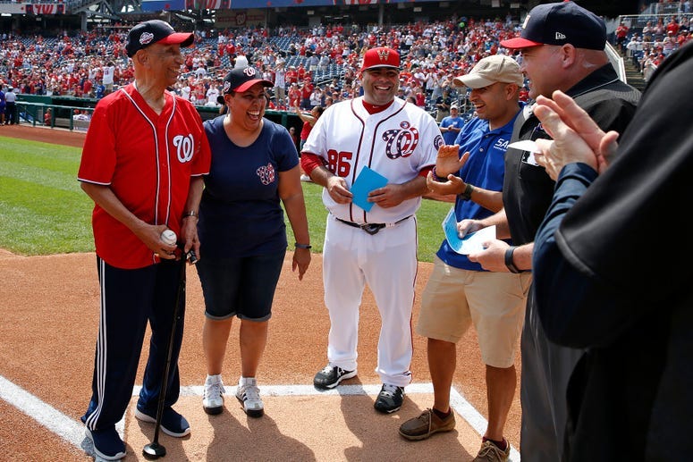 World War II veteran Ellsworth Hutchinson, Jr. delivers game ball