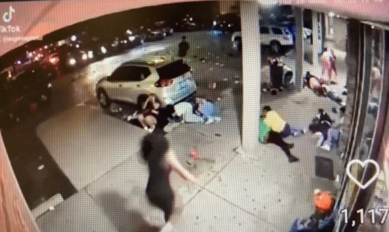 screen grab of people fleeing strip mall