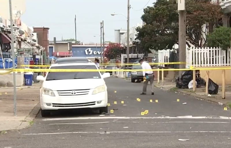 Police investigate the scene of a quadruple shooting in Juniata Saturday afternoon.
