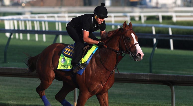 Kentucky Derby and Preakness winner Justify and exercise rider Humberto Gomez take to the track on May 28, 2018, in Louisville, Kentucky.