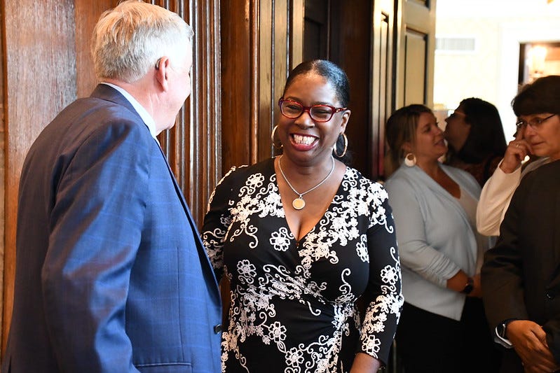 State Sen. Karla May, D-St. Louis, talks with Gov. Mike Parson at a 2021 bill signing ceremony.