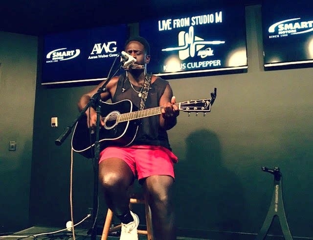Kashus Culpepper with acoustic guitar