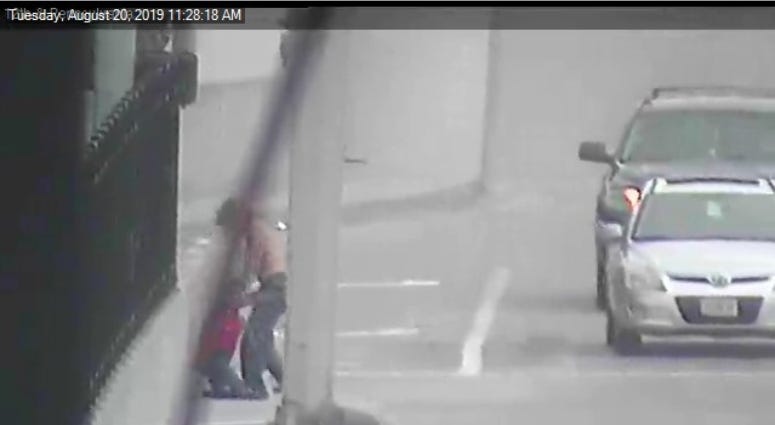 traffic camera image of man dragging sex doll
