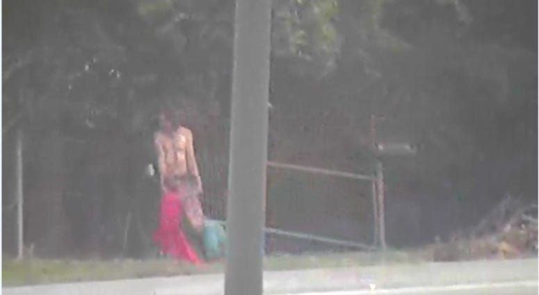 traffic camera image of man dragging sex doll