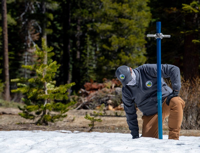 Sean de Guzman, chief of California Department of Water Resources (DWR), Snow Surveys and Water Supply Forecasting Section, conducts the final snow survey of the 2020 season at Phillips Station in the Sierra Nevada Mountains.