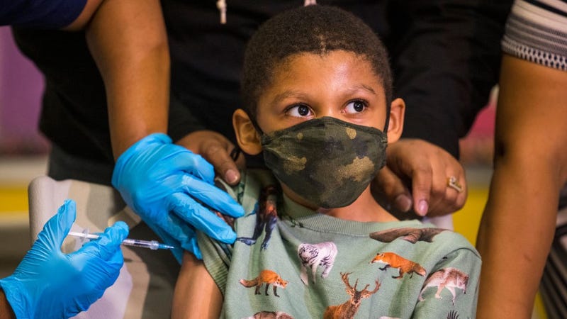 Christopher Reyes, 9, sits silently as he is administered the coronavirus (COVID-19) vaccine at a vaccination pop-up site at P.S. 19 on November 08, 2021 in the Lower East Side in New York City. 