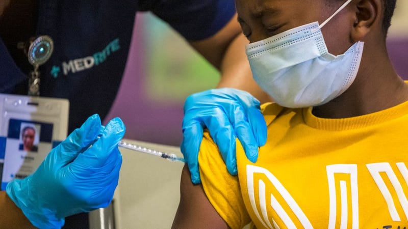  Tse Cowan, 8, winces as he is administered the coronavirus (COVID-19) vaccine at a vaccination pop-up site at P.S. 19 on November 08, 2021 in the Lower East Side in New York City. 