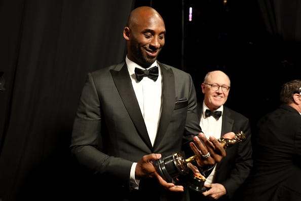 Kobe Bryant admires the Oscar he won in 2018. 