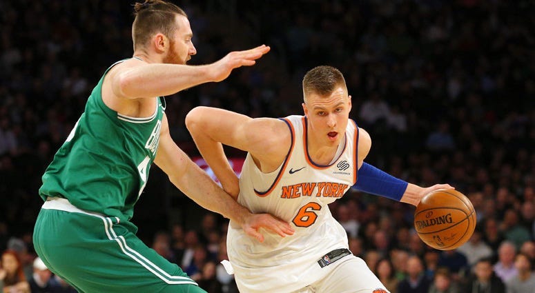 Knicks power forward Kristaps Porzingis drives against Celtics center Aron Baynes on Dec. 22, 2017, at Madison Square Garden. 
