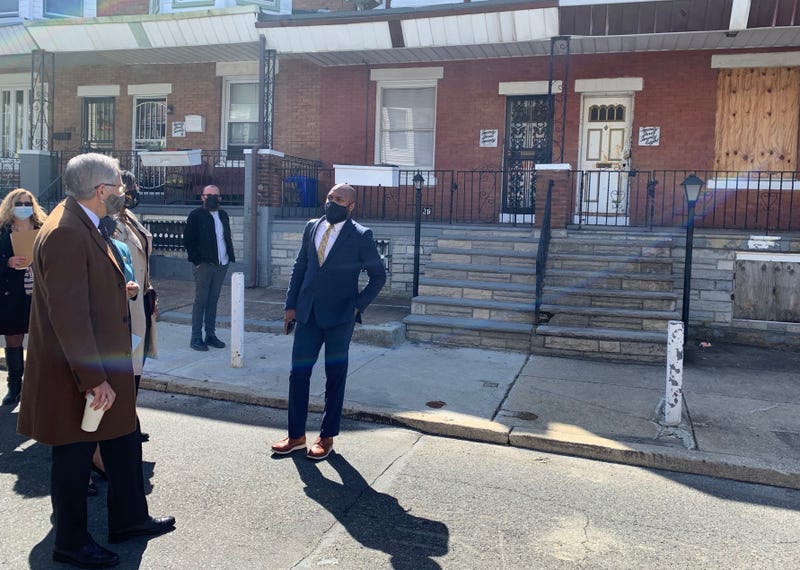 Philadelphia District Attorney Larry Krasner stands in front of a boarded-up Strawberry Mansion rowhome at the center of a case of house theft.