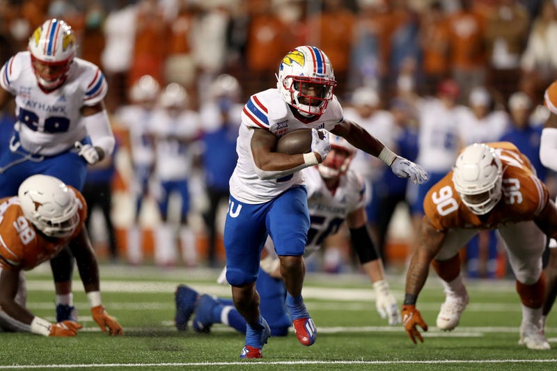 Devin Neal #4 of the Kansas Jayhawks rushes for a touchdown in the third quarter against the Texas Longhorns.