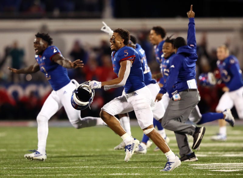 Wide receiver Stephon Robinson Jr. #5 and the Kansas Jayhawks storm the field and celebrate as they defeat the Texas Tech Red Raiders 37-34 to win the game at Memorial Stadium on October 26, 2019 in Lawrence, Kansas.