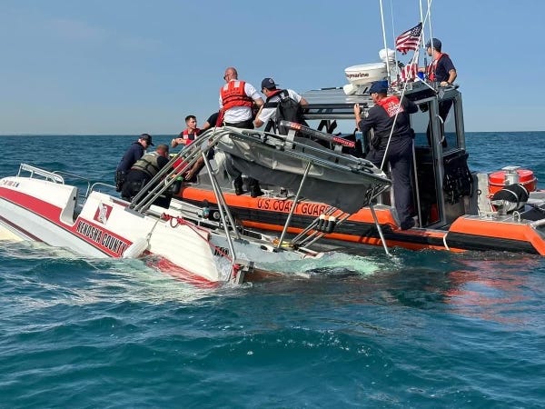 boat taking on water, crew rescued.