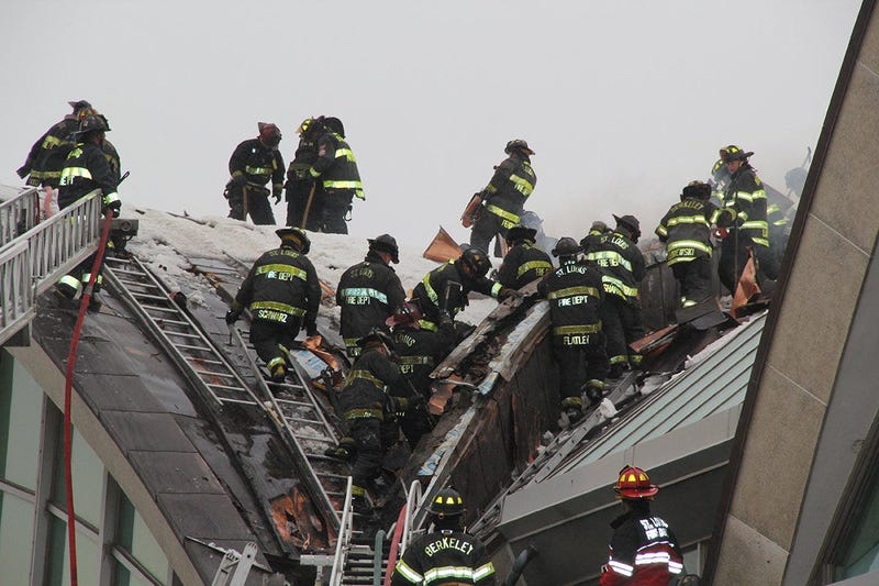 Firefighters fighting fire in roof at St. Louis Lambert International Airport.
